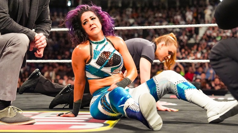 Bayley sits in the ring on 