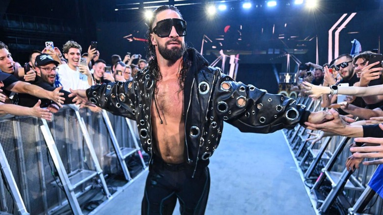 Seth Rollins high fives fans as he makes his way down to the ring for a King of the Ring tournament match on "WWE Raw."
